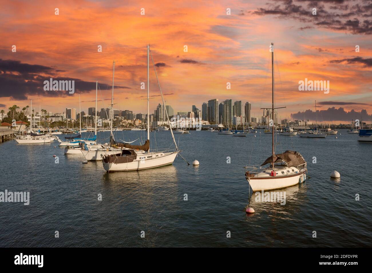 Downtown towers and peaceful marina with sunset sky in scenic San Diego, California Stock Photo