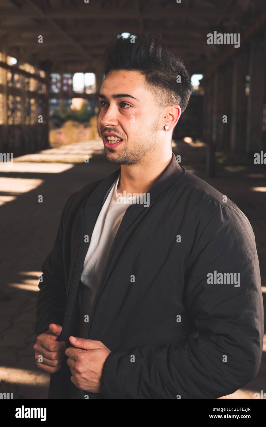 Young caucasian man posing in a abandoned pavilion. Stock Photo