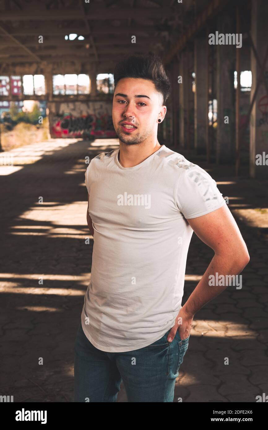 Young caucasian man posing in a abandoned pavilion. Stock Photo