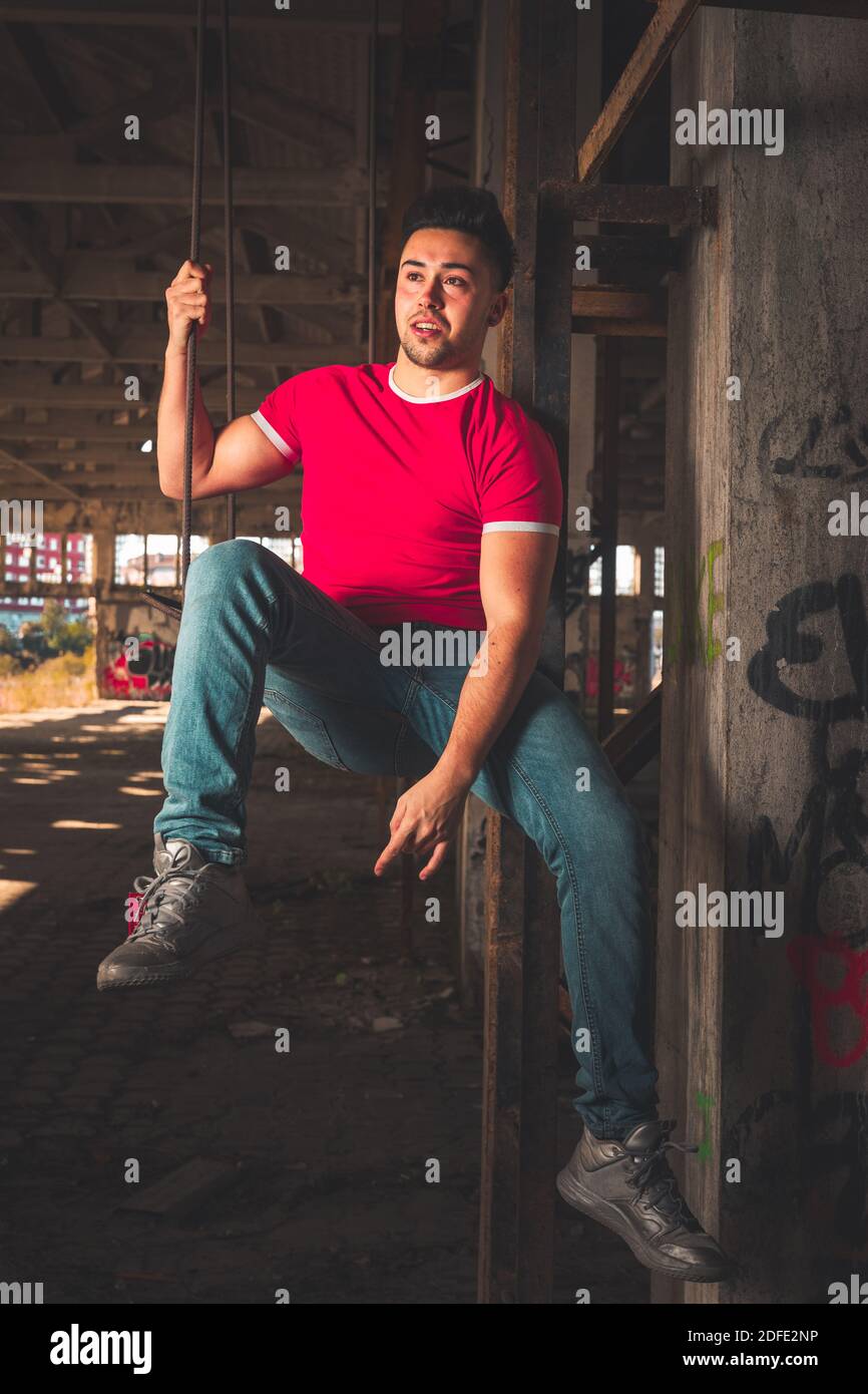 Young caucasian man posing in a abandoned pavilion. Stock Photo