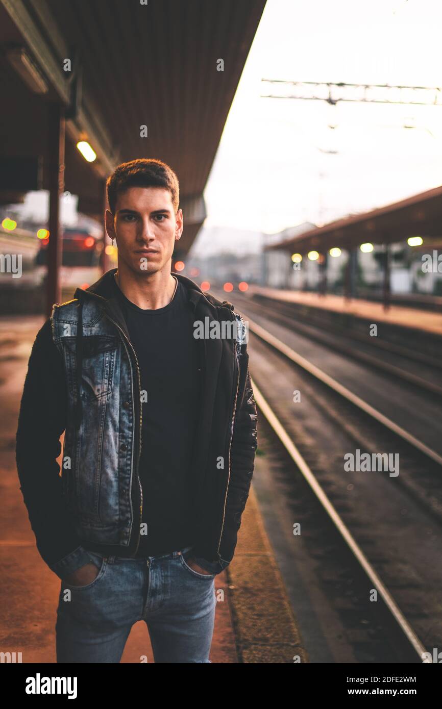Young man waiting at the train station Stock Photo Alamy