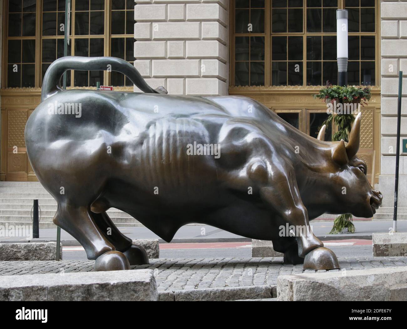 New York, United States. 04th Dec, 2020. Pedestrians walk by the Charging Bull statue in New York City on Friday, December 4, 2020. The Dow jumped to a new record despite poor news in the job market. Photo by John Angelillo/UPI Credit: UPI/Alamy Live News Stock Photo