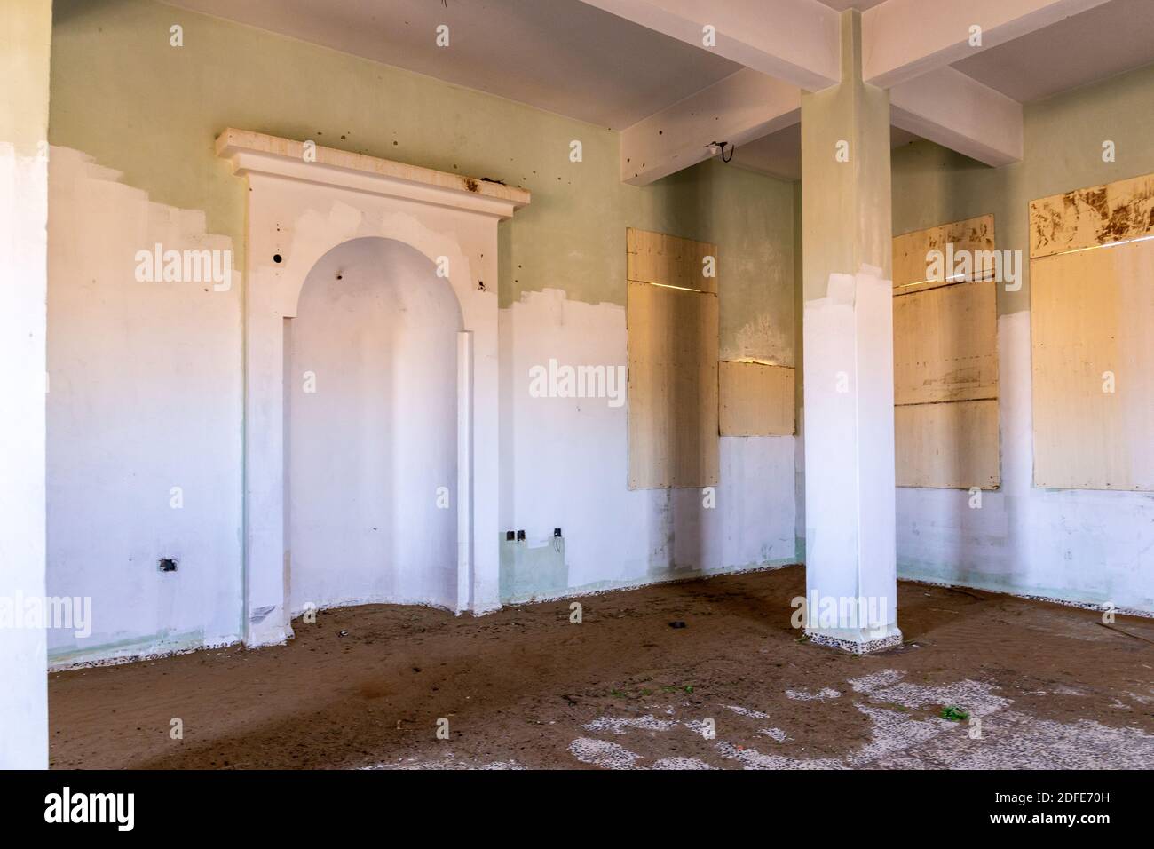 Demolished old mosque interior with qibla wall - mihrab (niche) in ghost village Al Madam in Sharjah, United Arab Emirates. Stock Photo