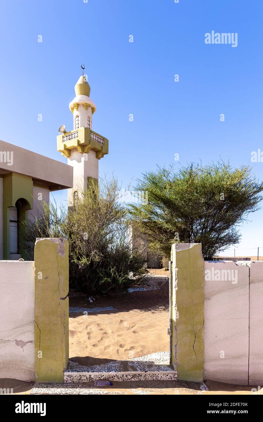 Entrance to demolished old mosque with minaret buried in sand in ghost village Al Madam in Sharjah, United Arab Emirates. Stock Photo