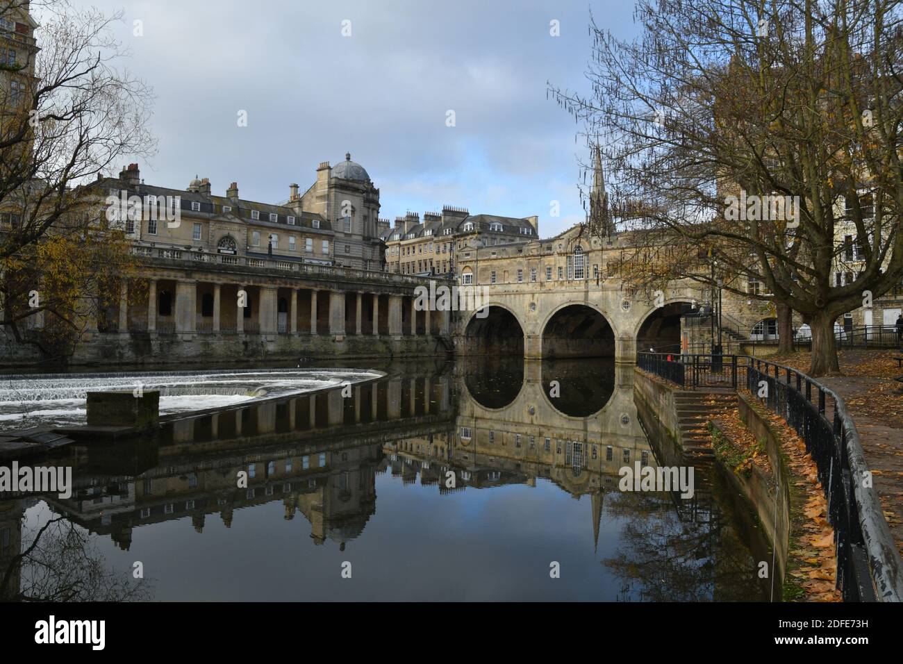 Pultney bridge reflected in the river Avon above the weir on a bright autumn day in Bath, Somerset.UK Stock Photo