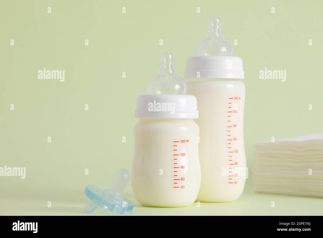 A selective focus shot of bottles of formula and a pacifier Stock Photo