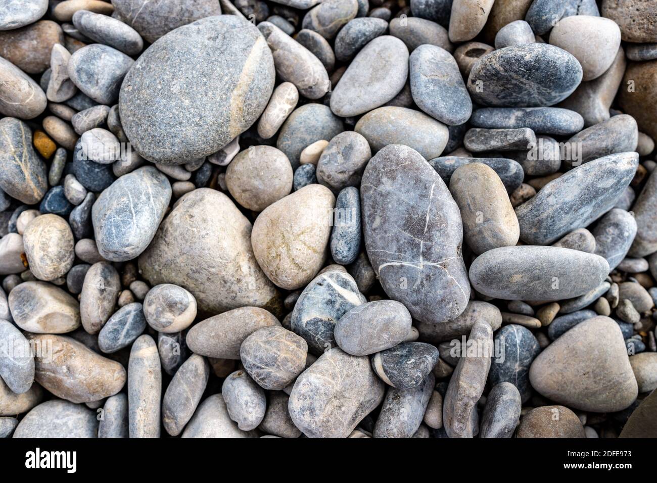 Different stones as texture background, flat lay Stock Photo
