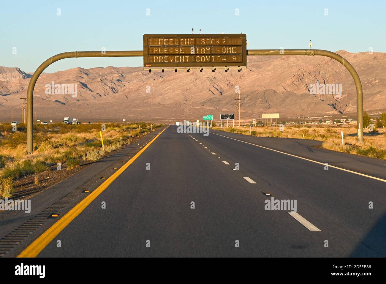 Signage over Interstate 15 North urges “Feeling Sick? Please Stay Home Prevent Covid-19”, Tuesday, Nov. 10, 2020, Littlefield, Ariz. (Dylan Stewart/Im Stock Photo