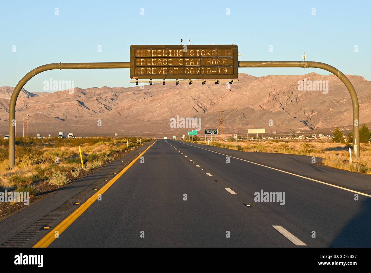 Signage over Interstate 15 North urges “Feeling Sick? Please Stay Home Prevent Covid-19”, Tuesday, Nov. 10, 2020, Littlefield, Ariz. (Dylan Stewart/Im Stock Photo