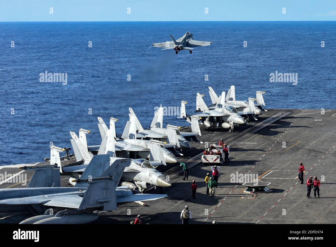 Hand out photo dated July 5, 2020 of An F/A-18E Super Hornet attached to the Eagles of Strike Fighter Squadron (VFA) 115 takes off from the flight deck of the Navy’s only forward-deployed aircraft carrier USS Ronald Reagan (CVN 76). Ronald Reagan is the flagship of Carrier Strike Group (CSG) 5. For the first time in six years, two US Navy aircraft carriers are in the South China Sea. The two US carriers arrived in the region as China wrapped up its own set of naval exercises near a disputed island chain. Beijing's state media carried reports boasting of the country's readiness to repel any US Stock Photo