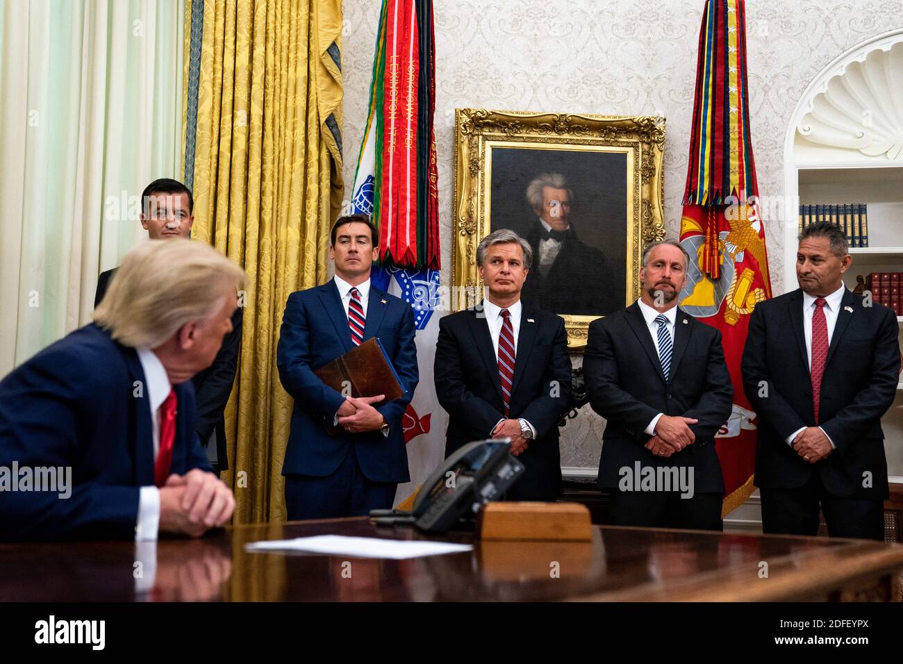 From left to right: Nicholas Trutanich, United States Attorney, District of Nevada, Zachary Terwilliger, United States Attorney, Eastern District of Virginia, Director Christopher Wray, Federal Bureau of Investigation, Matthew Albence, Acting Director, Immigration and Customs Enforcement, Department of Homeland Security, right, and Michael Carvajal, Director of the Federal Bureau of Prisons, look on as President Donald Trump addresses reporters in the Oval Office of the White House after receiving a briefing from law enforcement on 'Keeping American Communities Safe: The Takedown of Key MS-13 Stock Photo