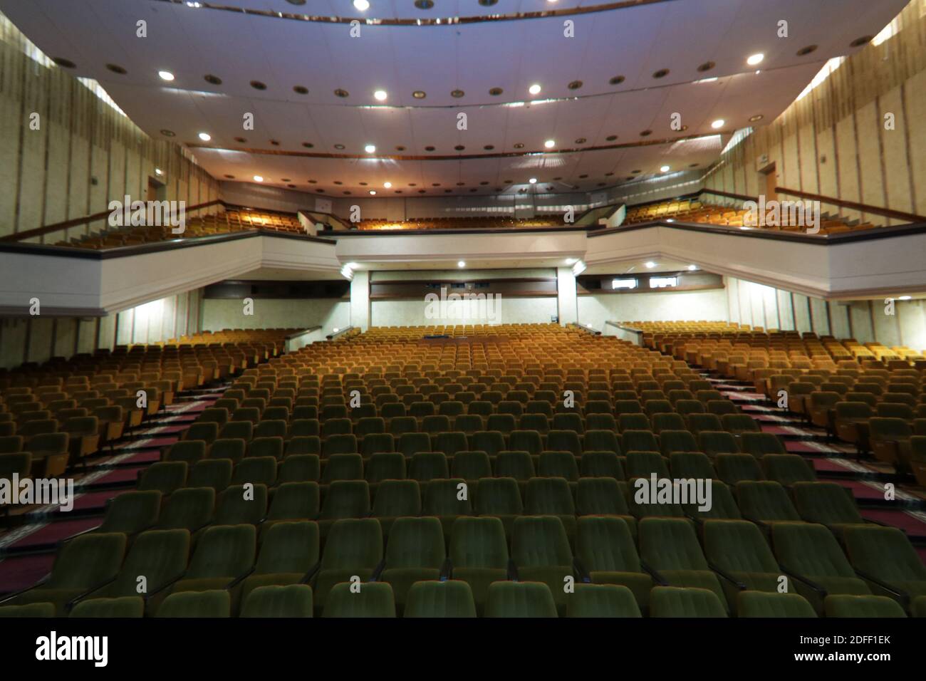 Interior of a concert hall or theater with light and velvet chairs ...