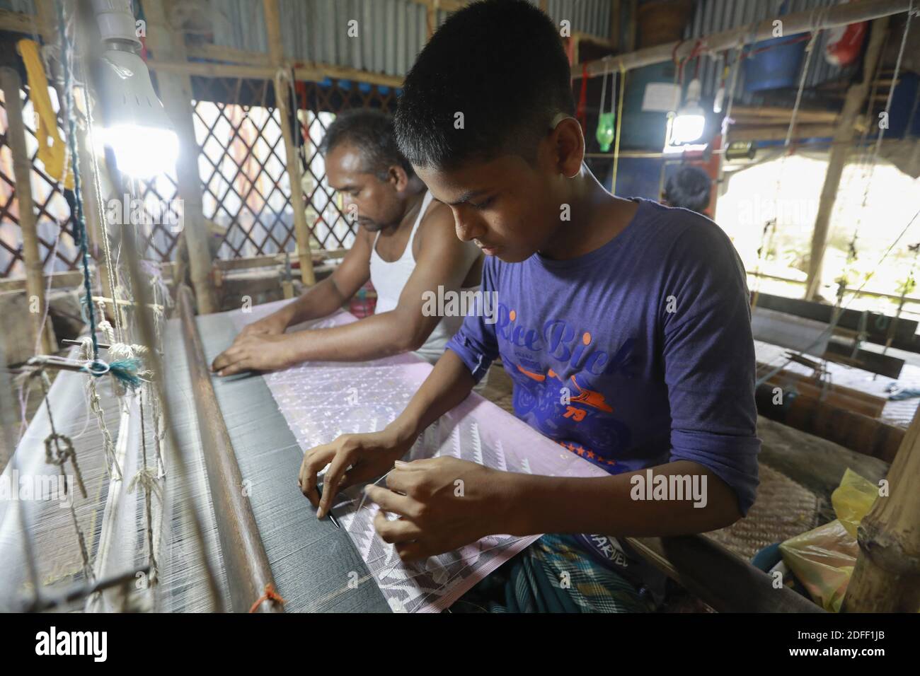 Handloom weaver weaves Jamdani saree on a traditional wooden hand