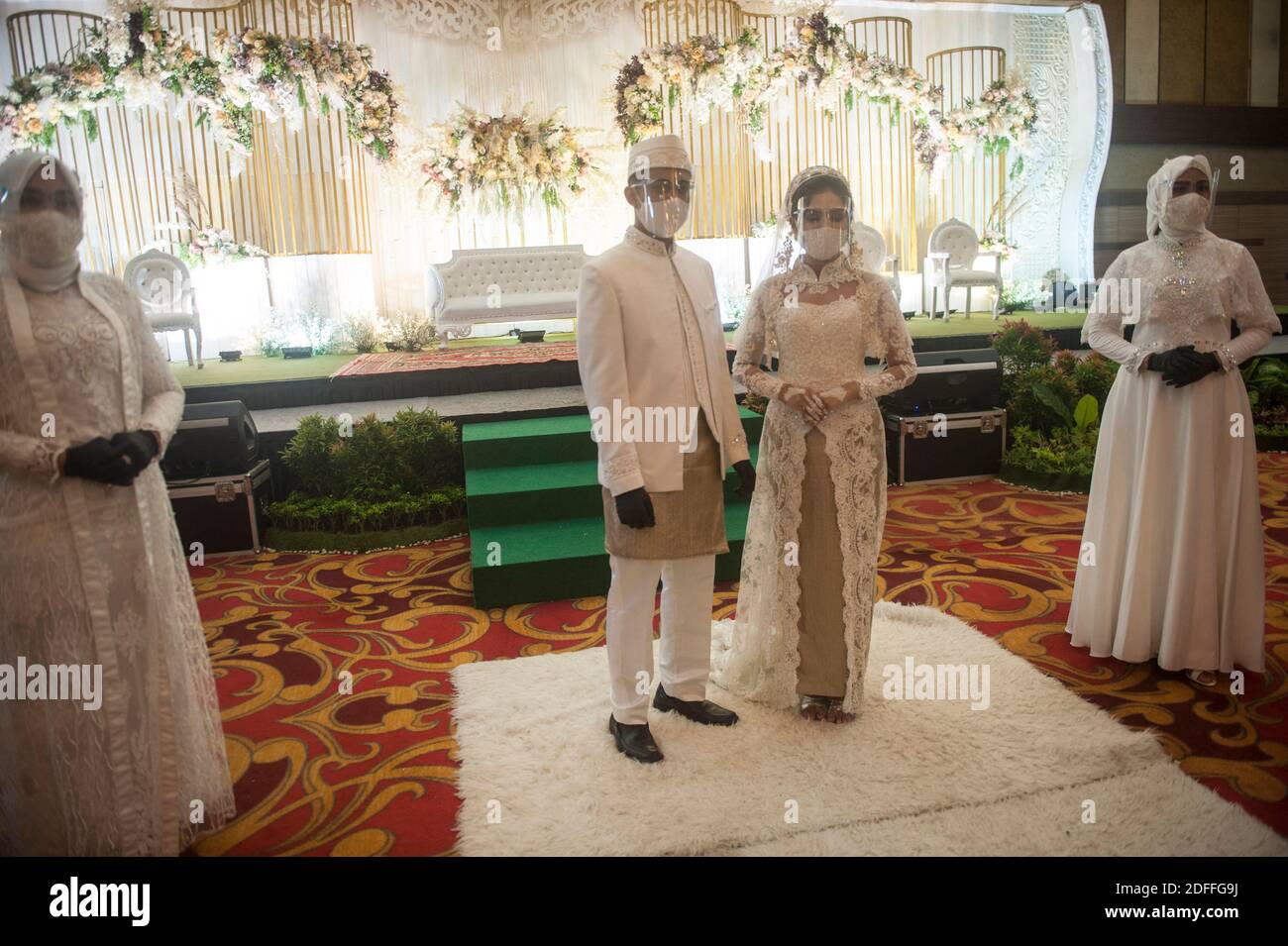 A married couple seen using face shield in carrying out a wedding ceremony  during a simulation about the standarism of health protocol for wedding  during the new normal on COVID-19 pandemic outbreak, image size:1300x955