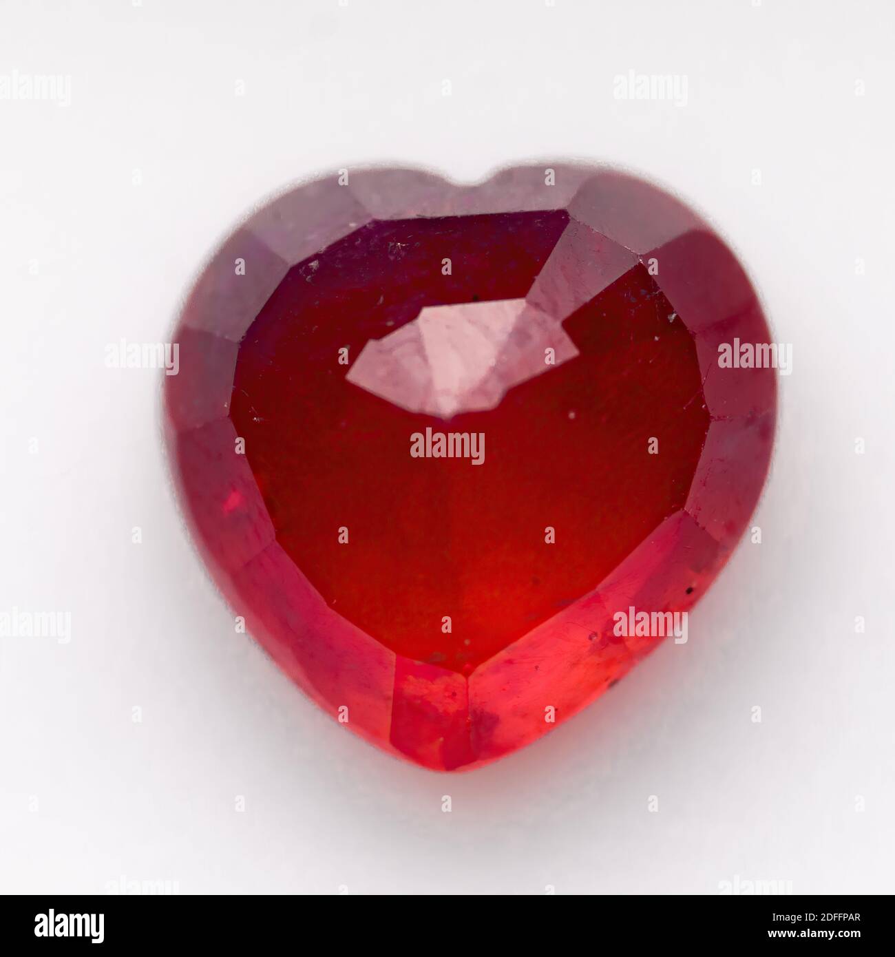 Natural ruby in the shape of a heart on a white background Stock Photo