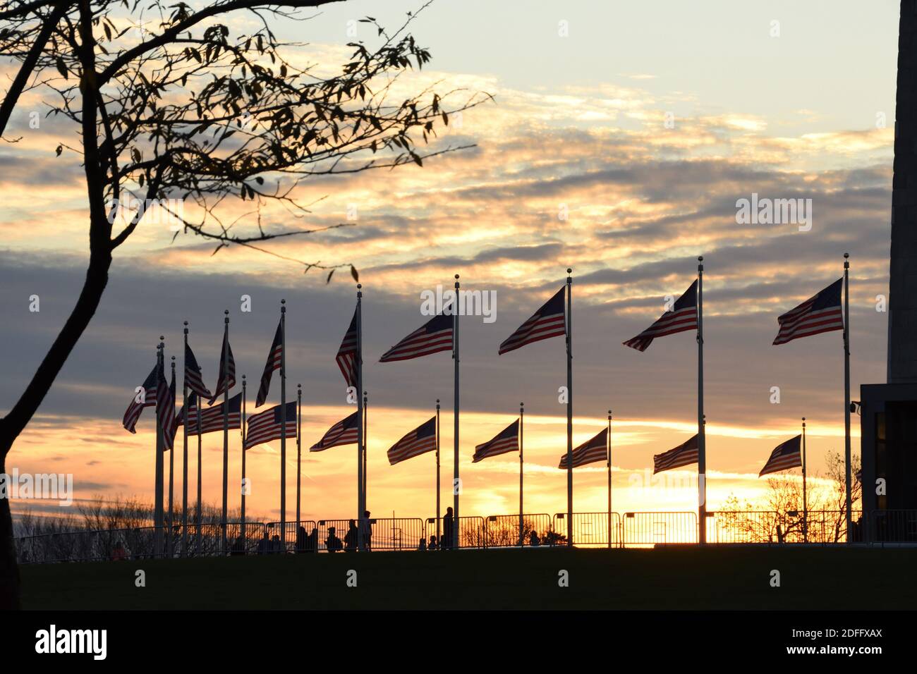 The circle of American flags at Washington Monument at Sunset. Washington DC, USA. Stock Photo