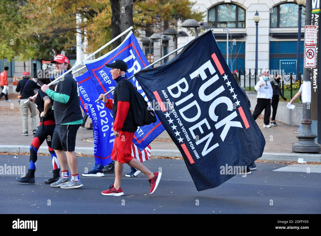 Washington DC. November 14, 2020. Million Maga March. Three men wearing shorts walking with Trump flags and F Biden flag. Stock Photo