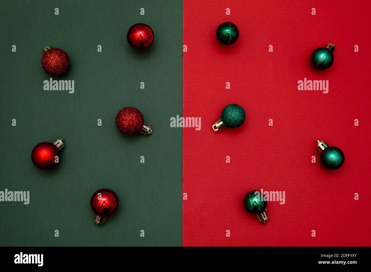 Christmas decoration in red and green color on dual tone background. Flat lay. Minimal Christmas concept Stock Photo