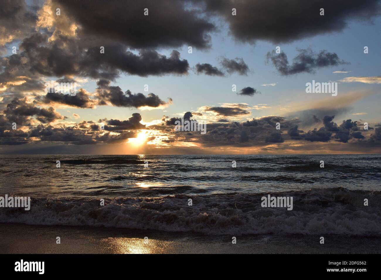 Wintery weather.Rome.Italy. Sunset.Light.Orange.Blue.Grey.Purple. Sea waves Stock Photo