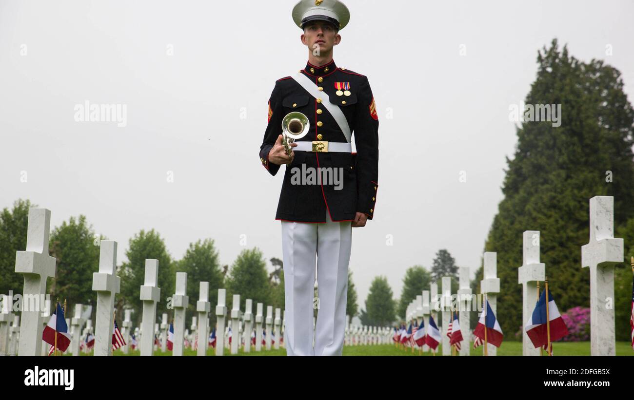Hand out file photo dated May 29, 2016 of Cpl. Lucas DeValder, trumpet player with 2nd Marine Division band, stands at attention during a Memorial Day ceremony in which U.S. Marines performed alongside the French Army at the Aisne-Marne American Memorial Cemetery in Belleau, France. President Trump reportedly skipped his scheduled visit to the Aisne-Marne American Cemetery near Paris in 2018 after dismissing the U.S. soldiers who died during the Battle of Belleau Wood as “losers.” According to a report in The Atlantic published Thursday, Trump’s excuses of “the helicopter couldn’t fly” and tha Stock Photo