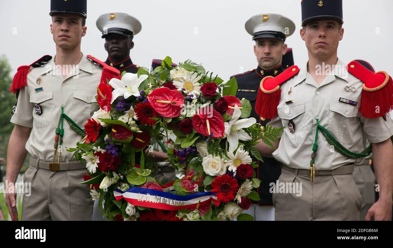 Hand out file photo dated May 29, 2016 of French soldiers and U.S. Marines carry wreaths during a Memorial Day ceremony in which U.S. Marines performed alongside the French Army at the Aisne-Marne American Memorial Cemetery in Belleau, France. The French and the Americans gathered together, as they do every year, to honor those service members from both countries who have fallen in WWI, Belleau Wood and throughout history, fighting side by side. The Marines also remembered those they lost in the Battle of Belleau Wood 98 years ago. President Trump reportedly skipped his scheduled visit to the Stock Photo