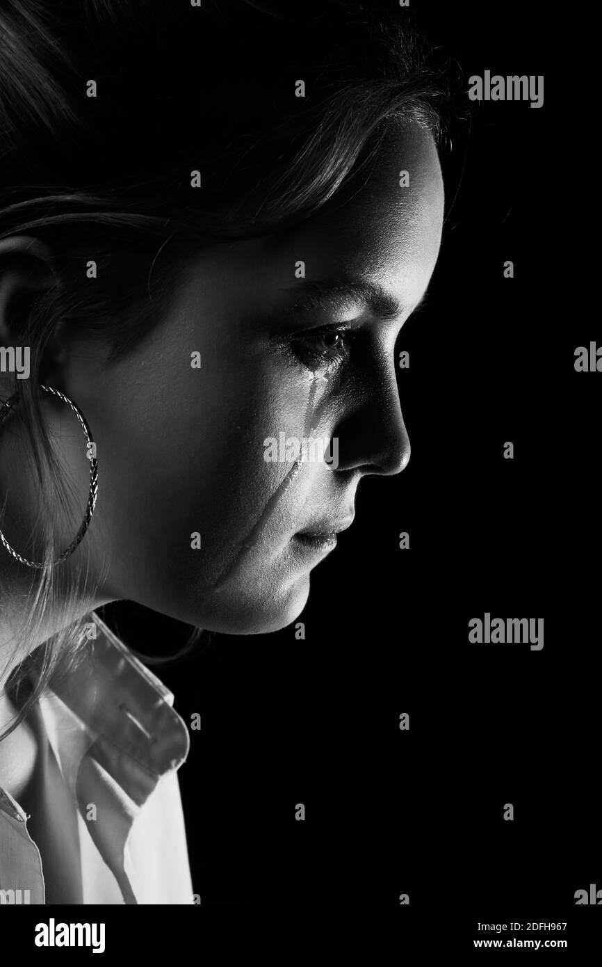 sad woman crying, looking aside on black background, closeup portrait,  profile view, monochrome Stock Photo - Alamy