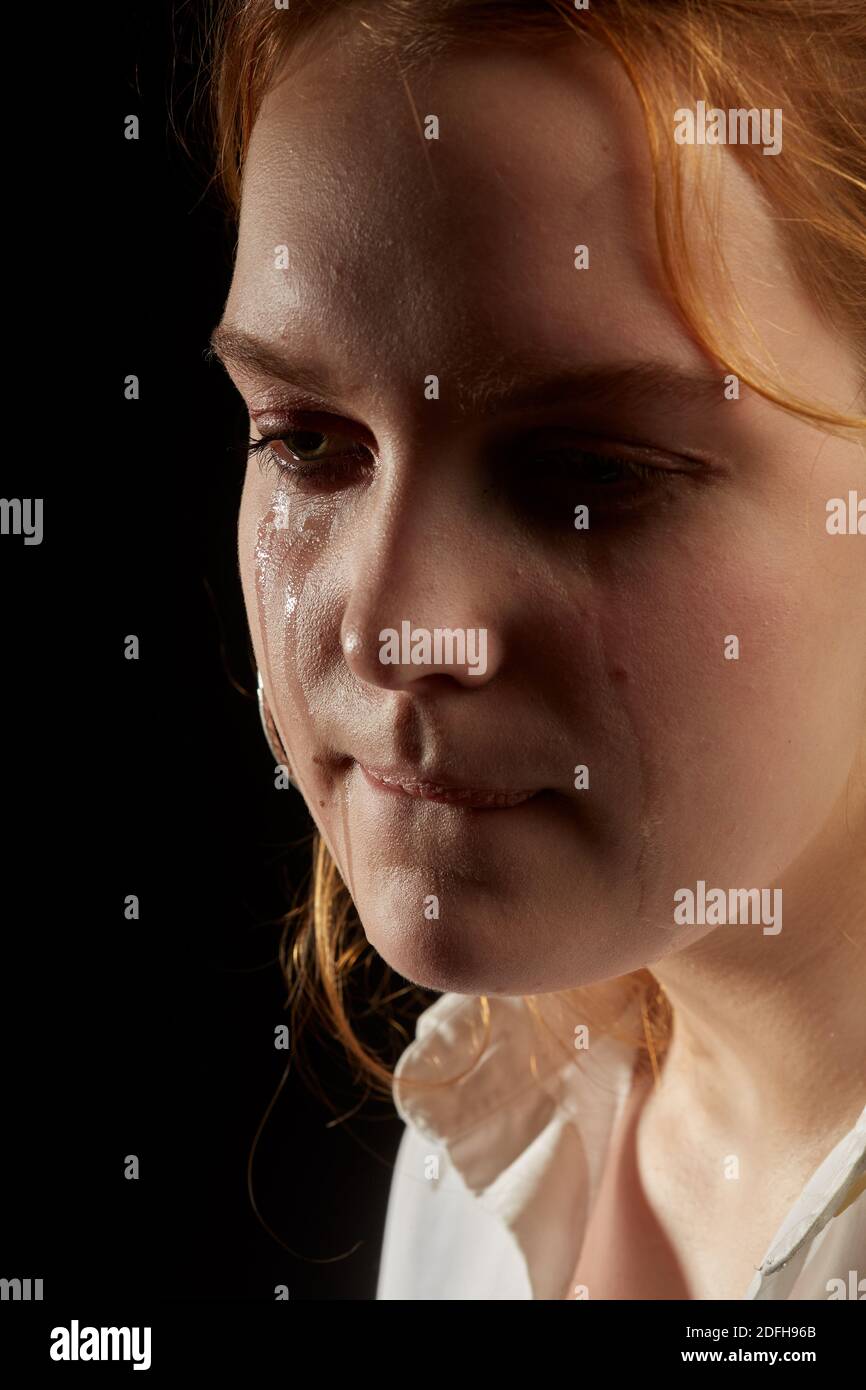 sad woman crying, looking aside on black background, closeup portrait,  profile view Stock Photo - Alamy