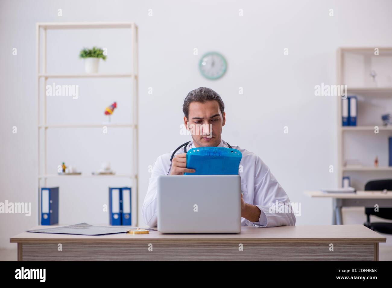 Young doctor taking notes at the hospital Stock Photo - Alamy