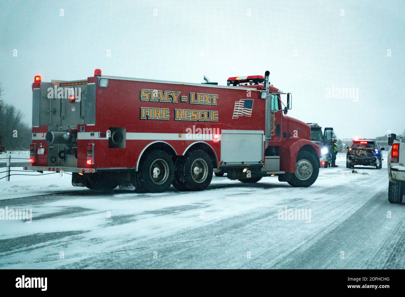 Fire truck arrives at the scene of an accident due to slippery roads on I-35 Freeway Stacy Minnesota MN USA Stock Photo