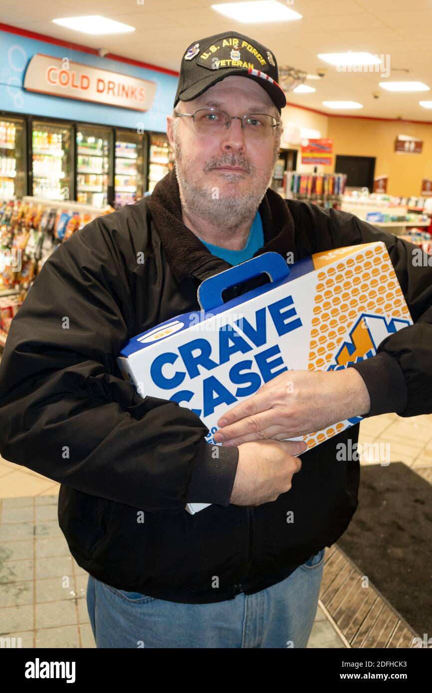 Man hugging a Crave Case of 40 White Castle hamburger sliders that he just purchased in the restaurant. Hinckley Minnesota MN USA Stock Photo