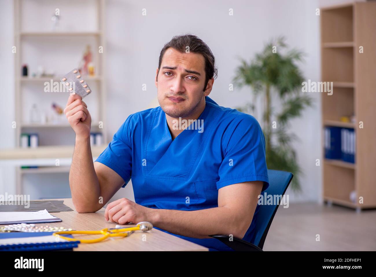 Young sick doctor being unhappy after night shift Stock Photo Alamy