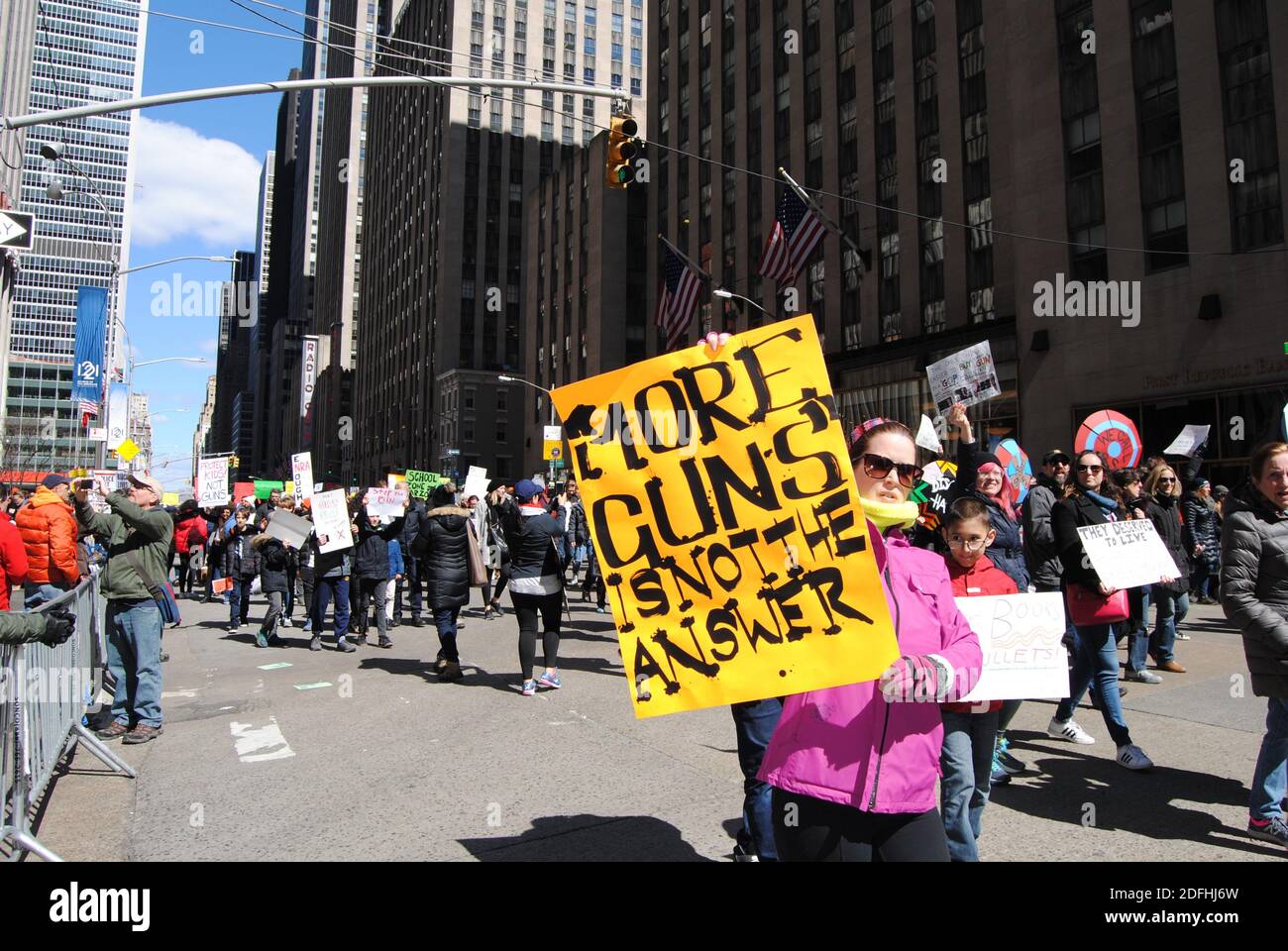 New York City, New York / USA - March 24 2018: A protester on 6th Avenue with a sign against guns during the March for Our Lives in New York City. Stock Photo