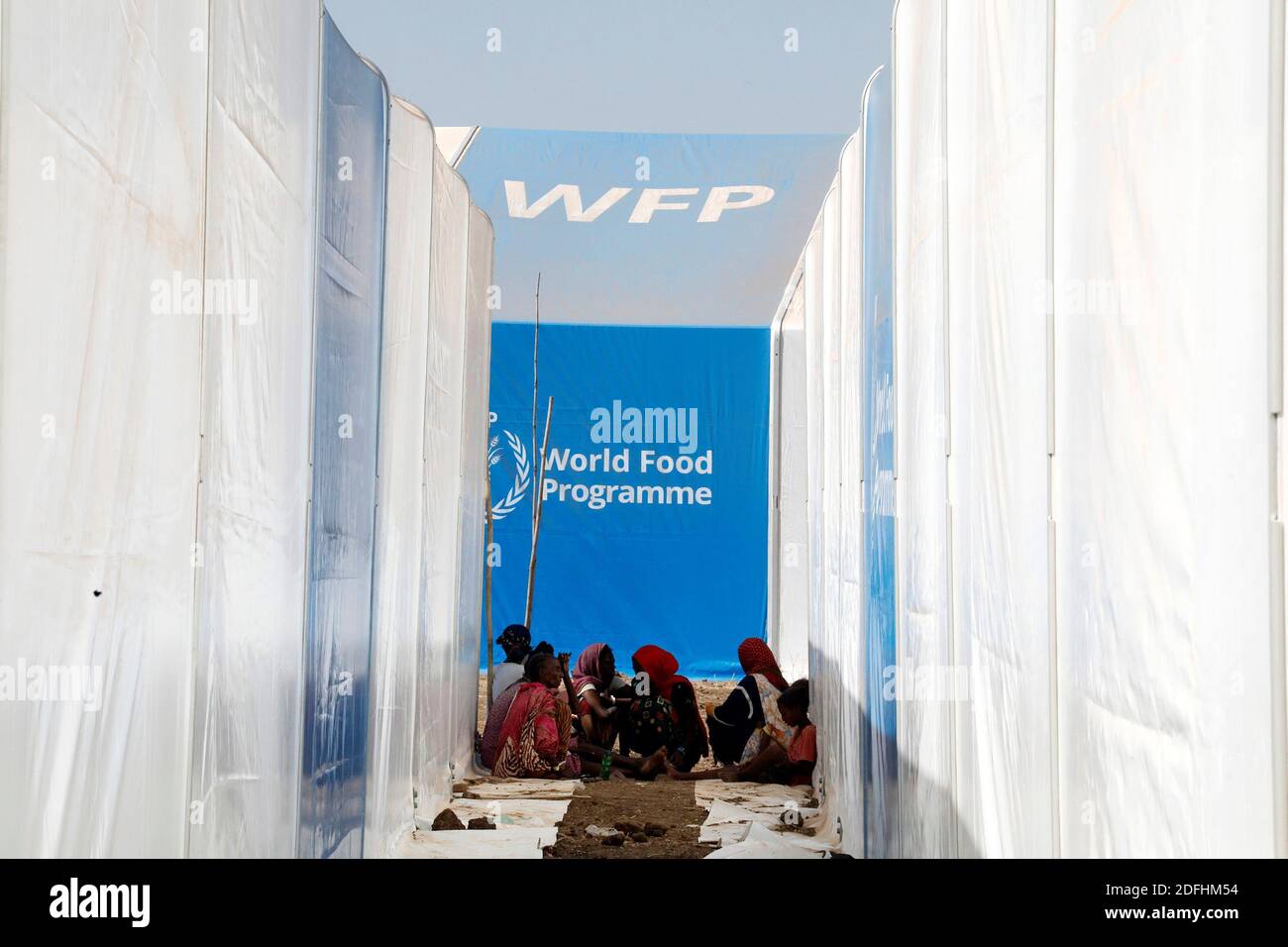 People wait for food aid from the WFP, at the Um Rakuba refugee camp which houses Ethiopians fleeing the fighting in the Tigray region, on the the border in Sudan, December 3, 2020. Picture taken December 3, 2020. REUTERS/Baz Ratner Stock Photo