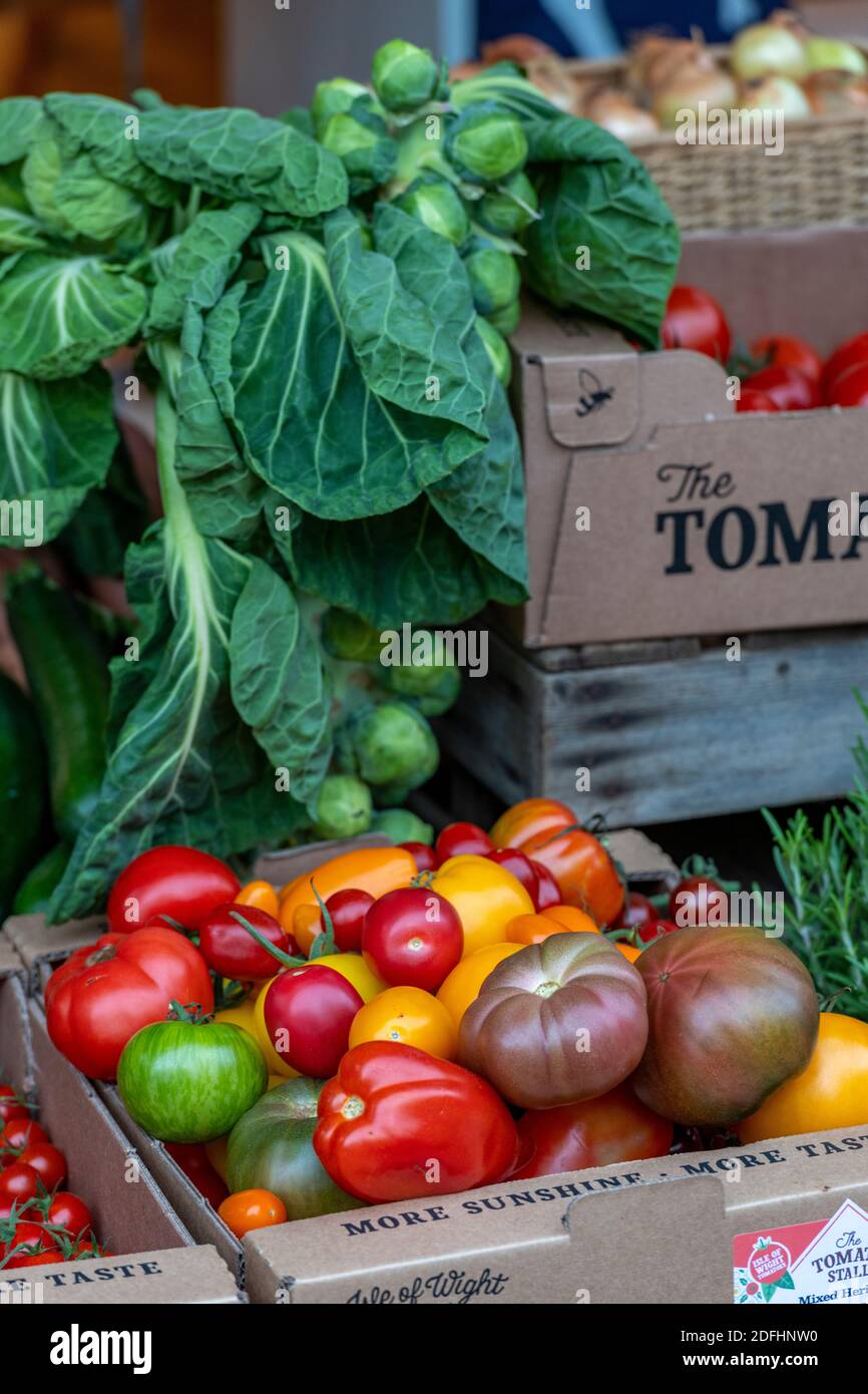 a variety of colourful tomatoes for sale on a market stall selling ...