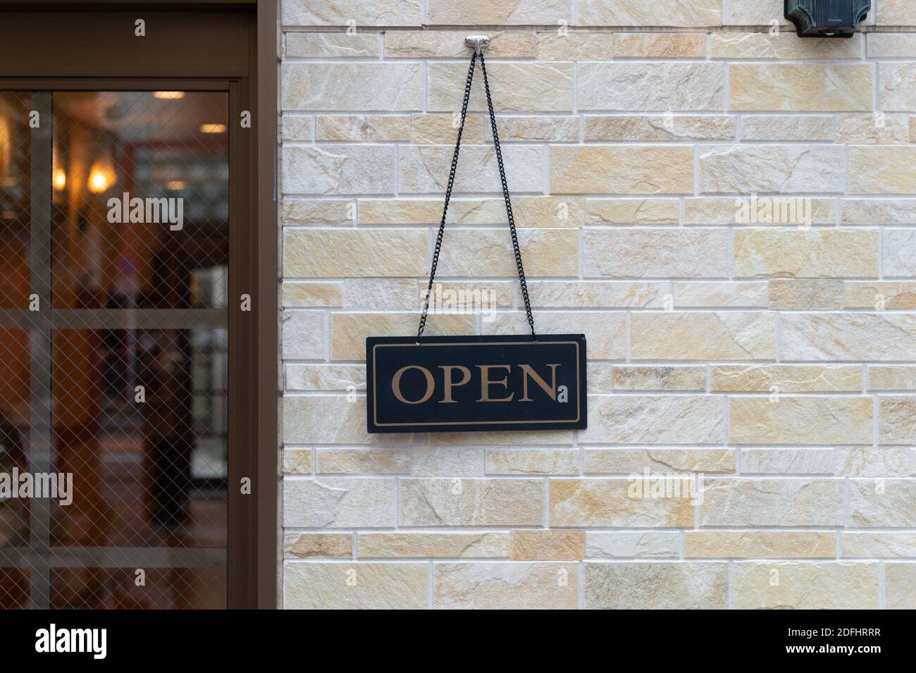 Open Sign Hanging on a Brick Wall Stock Photo Alamy