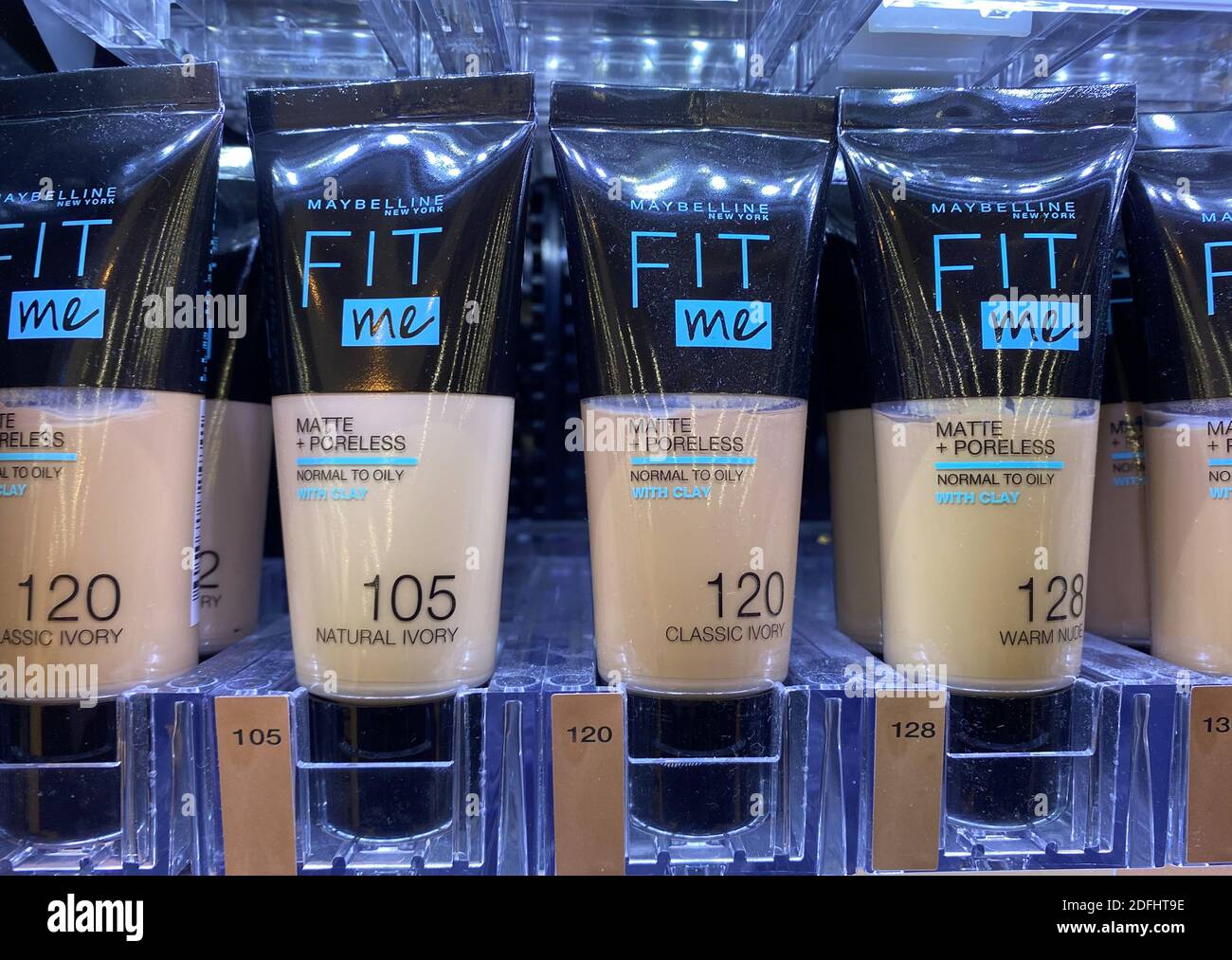 Viersen, Germany - May 9. 2020: Closeup of tubes Maybelline fit me makeup in shelf of german supermarket Stock Photo