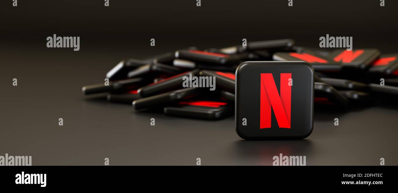 Logos of the on demand video site and app Netflix on a heap. One tile standing upright in front