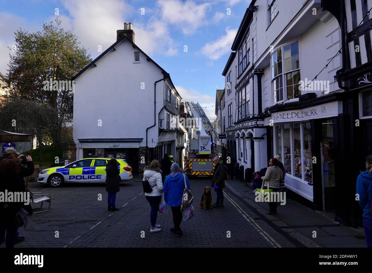 Totnes, UK. 5th Dec, 2020. Fire service platform ladder blocks the high street as it removes lead flashing from a house, which was in danger of falling onto pedestrians. Credit: Julian Kemp/Alamy Live News Stock Photo