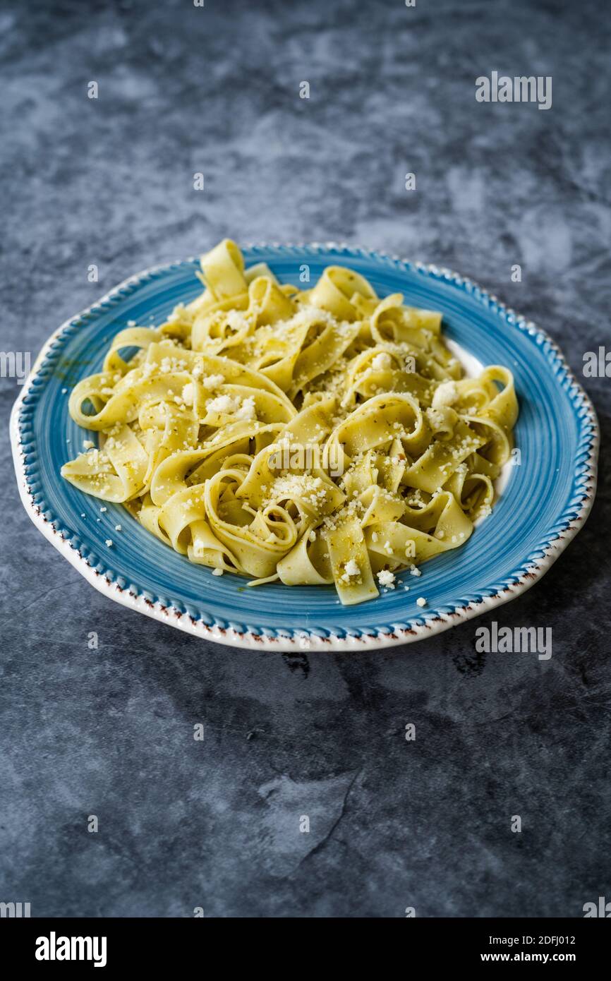 https://c8.alamy.com/comp/2DFJ012/pappardelle-pasta-with-grated-parmesan-cheese-par-in-plate-ready-to-serve-and-eat-traditional-dish-2DFJ012.jpg