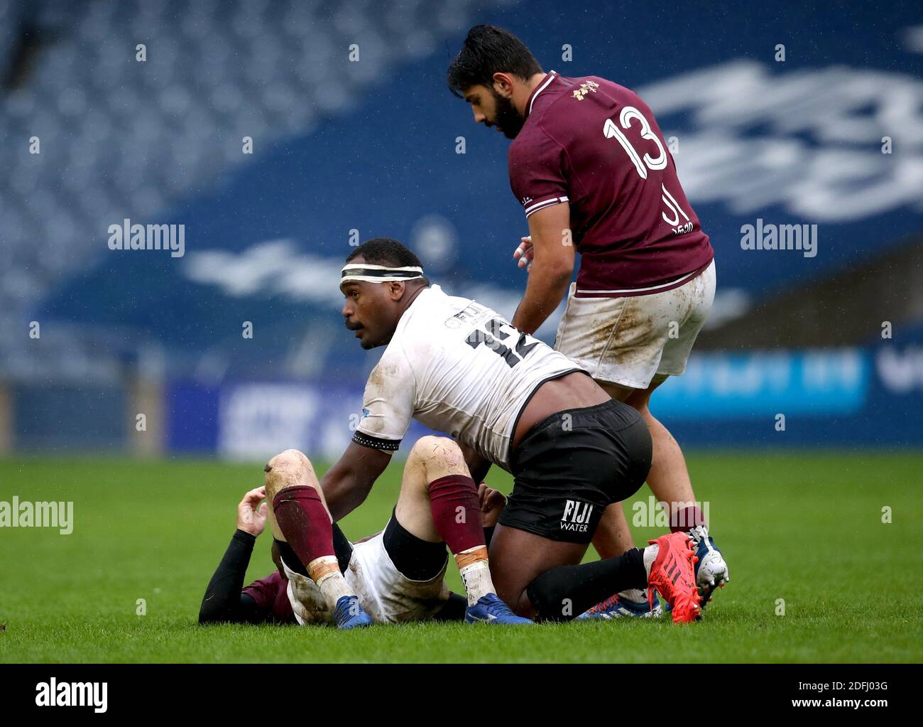 Georgia's Vasil Lobzhanidze (floor) is checked on by teammate Giorgi Kveseladze and Fiji's Levani Botia after going down during the Autumn Nations Cup match at BT Murrayfield stadium, Edinburgh. Stock Photo
