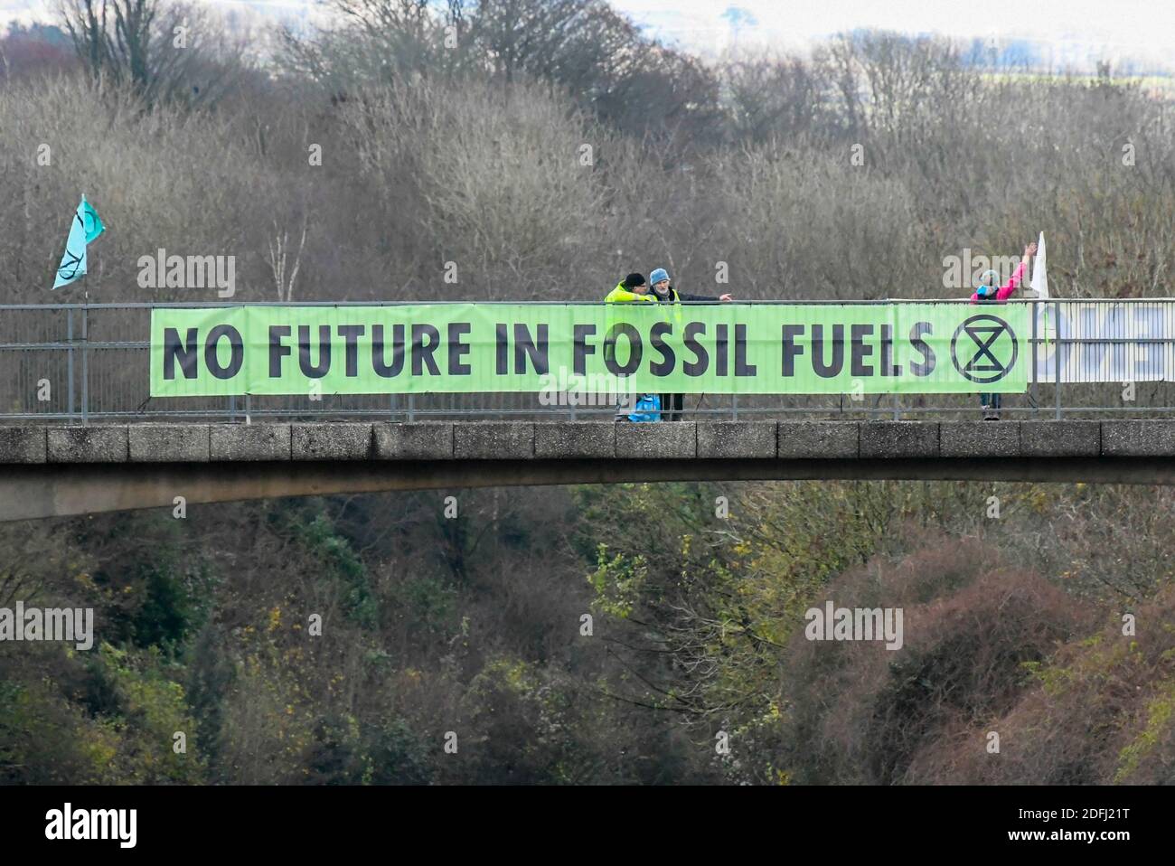 Plymouth Devon, UK.  5th December 2020.  Extinction Rebellion climate change protestors with banners saying “No Future in Fossil Fuels” on a bridge over the A38 at Plymouth in Devon. There are protestors with similar climate change messages on a number of bridges over the A38 between Exeter and Plymouth.  Picture Credit: Graham Hunt/Alamy Live News Stock Photo