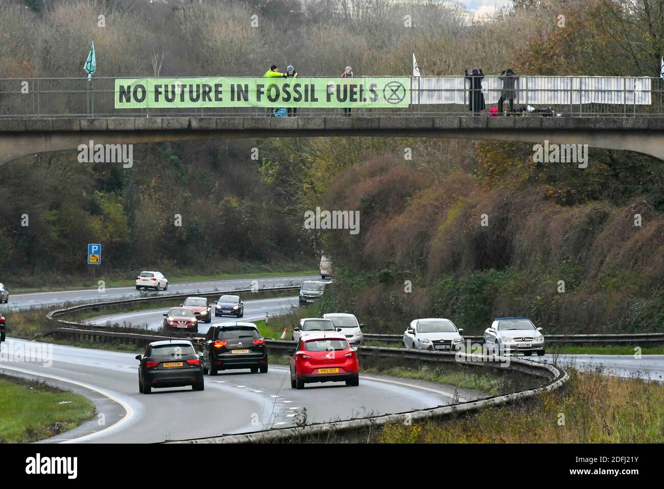 Plymouth Devon, UK.  5th December 2020.  Extinction Rebellion climate change protestors with banners saying “No Future in Fossil Fuels” on a bridge over the A38 at Plymouth in Devon. There are protestors with similar climate change messages on a number of bridges over the A38 between Exeter and Plymouth.  Picture Credit: Graham Hunt/Alamy Live News Stock Photo