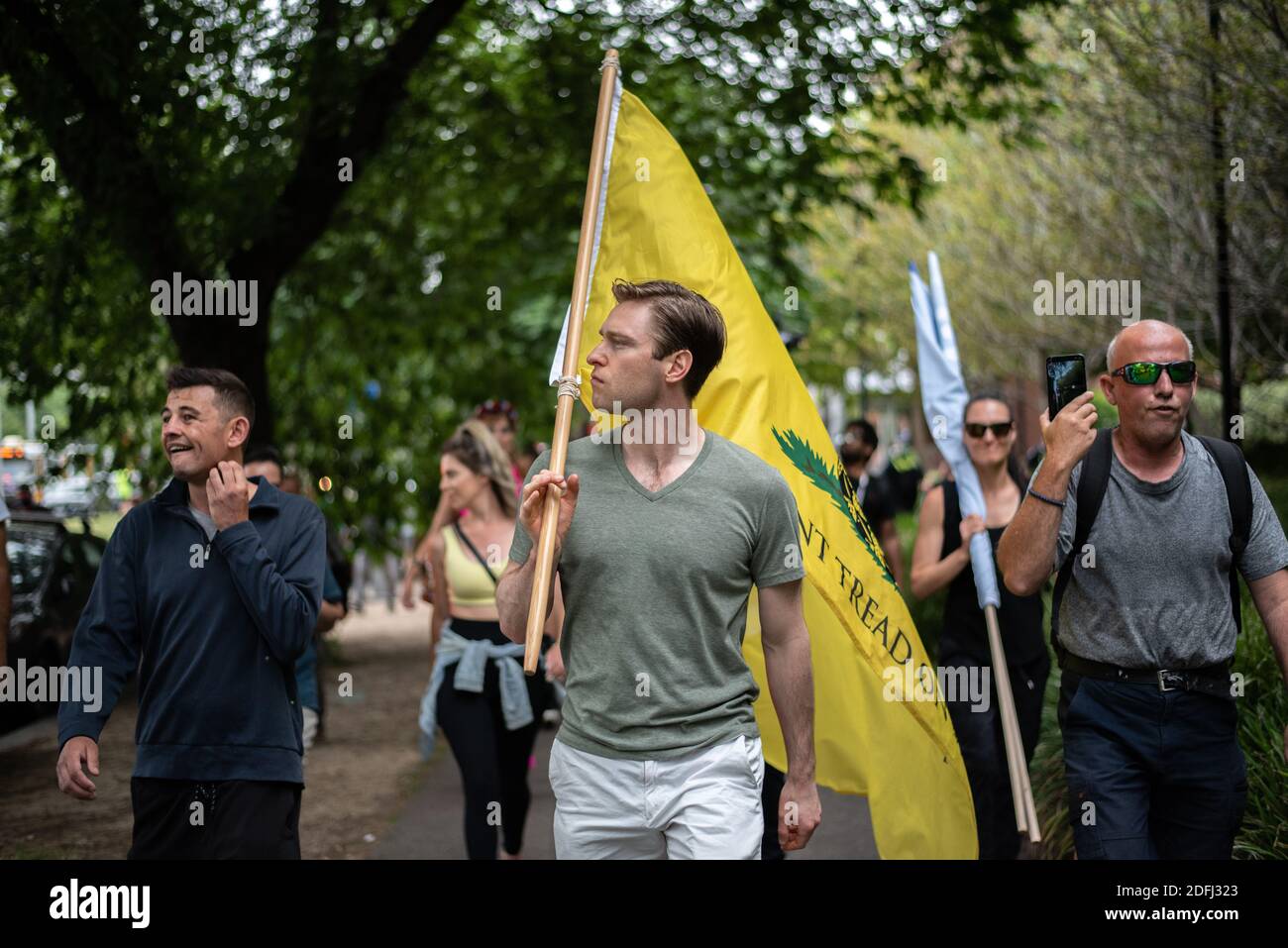 A protester marching with a “DON’T TREAD ON ME” flag at Saturday’s Melbourne Freedom Rally. Stock Photo