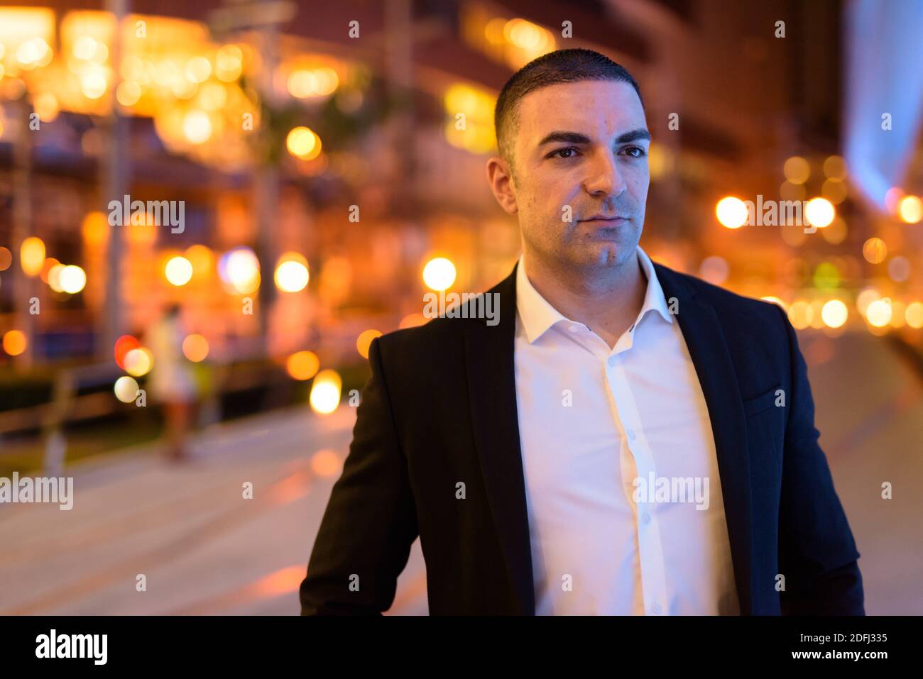 Pensive of businessman wearing suit outdoors at night in city Stock ...