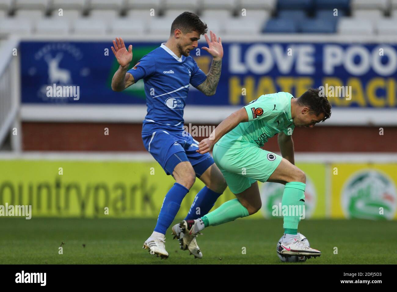 Hartepool, County Durham, UK. 27th Oct 2020. Hartlepool United's Gavan  Holohan in action with Altrincham's Tom Hannigan during the Vanarama  National League match between Hartlepool United and Altrincham at Victoria  Park, Hartlepool