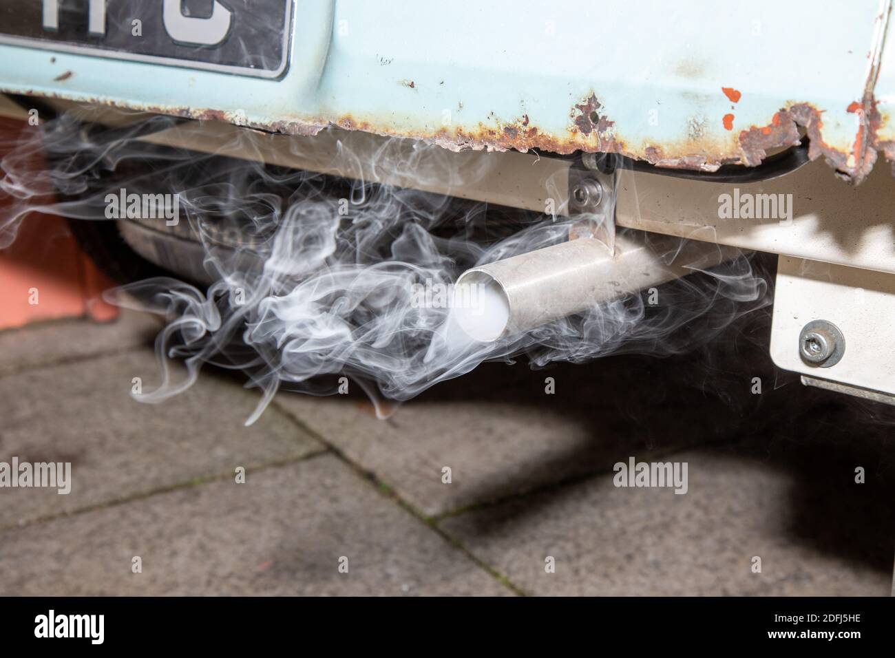 A smoking exhaust tail pipe from an old rusty car Stock Photo - Alamy