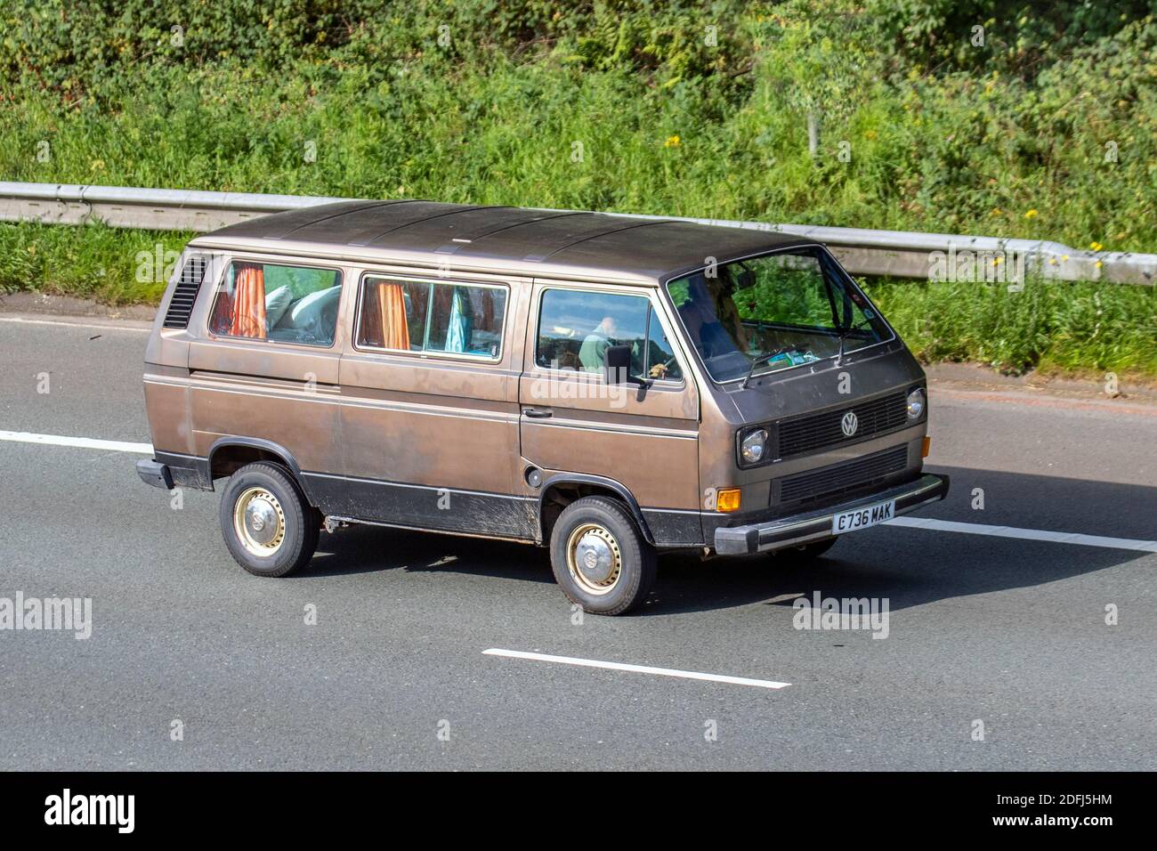 1986 80s eighties brown VW Volkswagen Caravelle 78Ps campervan Caravans and Motorhomes, 80s campervans on Britain's roads, RV leisure vehicle, family holidays, caravanette vacations, Touring caravan holiday, van conversions, Vanagon auto home, life on the road UK Stock Photo