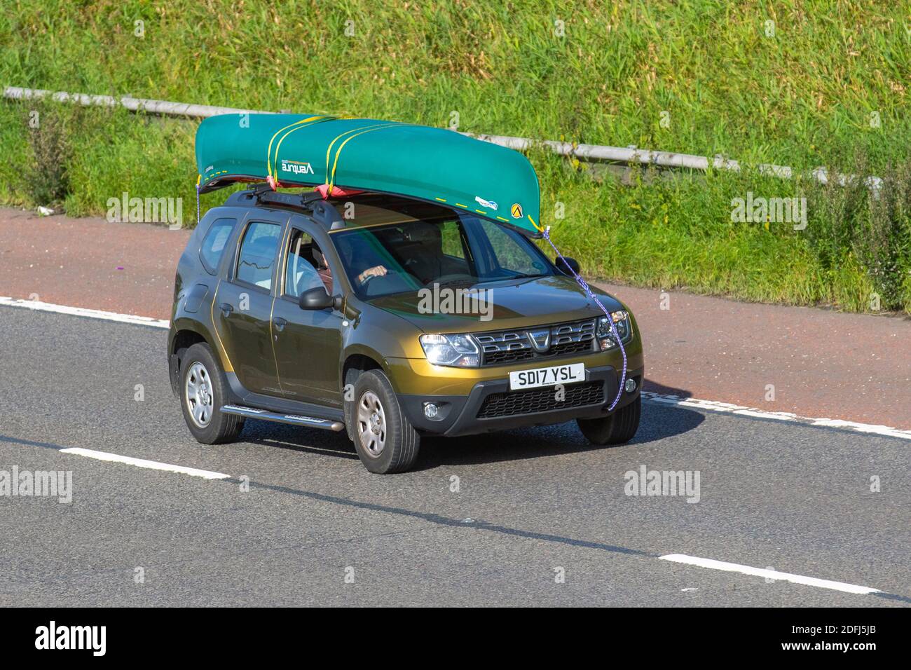 2017 green gold Dacia Duster Ambiance DCI 4X2; Vehicular traffic, moving vehicles, cars, vehicle driving on UK roads, motors, motoring on the M6 motorway highway UK road network. Stock Photo