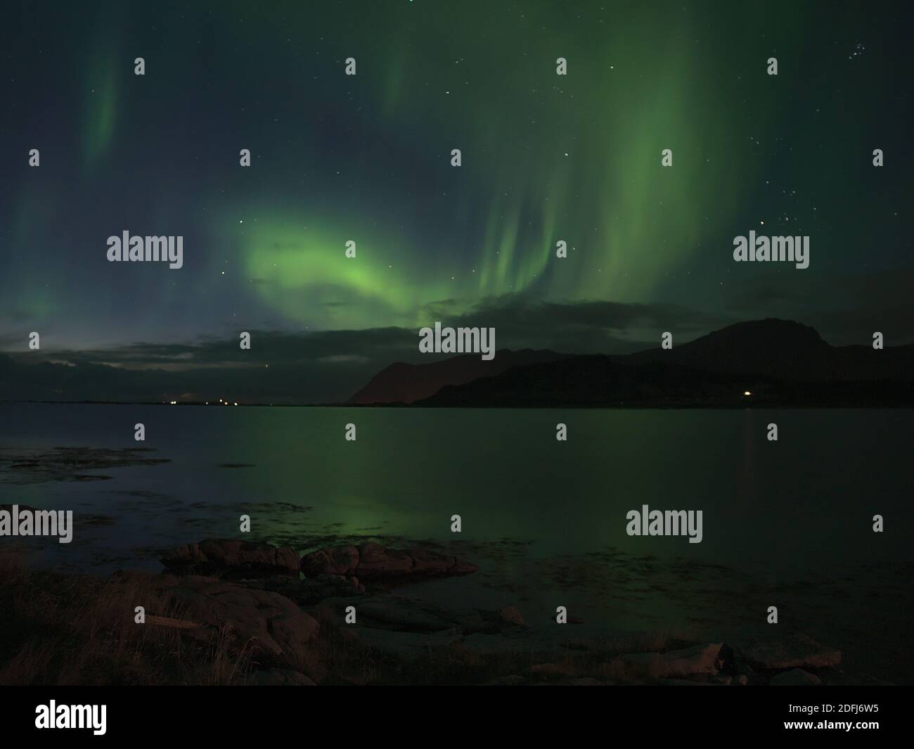 Stunning view of night sky with bright green colored northern lights ...