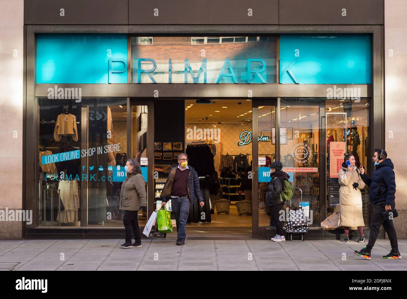 London, UK. 5 December 2020. Shoppers outside a Primark store in Oxford  Street on the first Saturday after lockdown restrictions were lifted on 2  December. Retailers are hoping that physical sales will